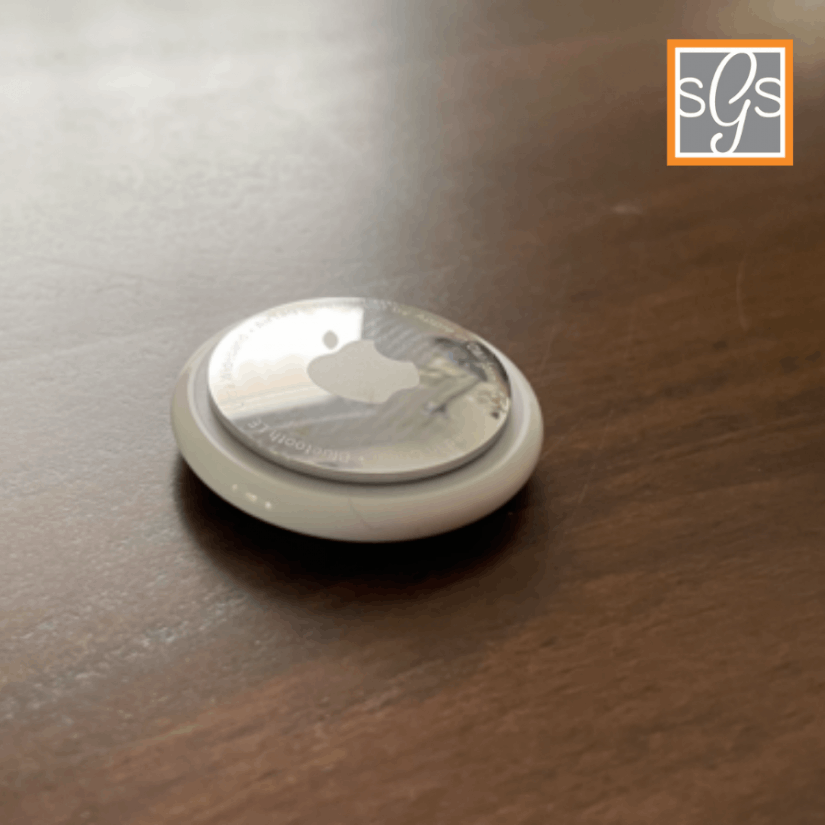 Apple AirTag on a brown color table