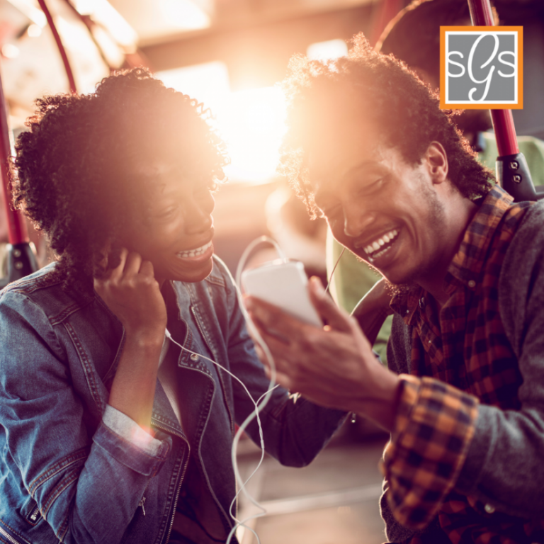 2 Black american couple listening to music with their smarthpone