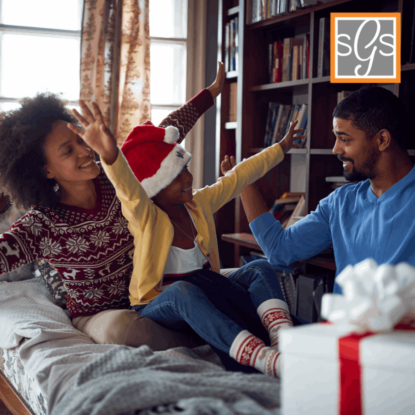 Happy black american family celebrating christmas on their sweet home